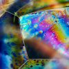 Photo of a large bubble with the light spectrum split across its surface